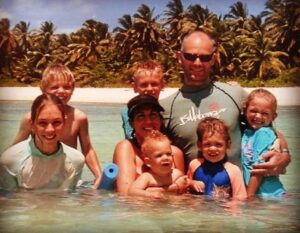 Howitt family with young children swimming in the Cocos Islands during early years of raising entrepreneurial kids