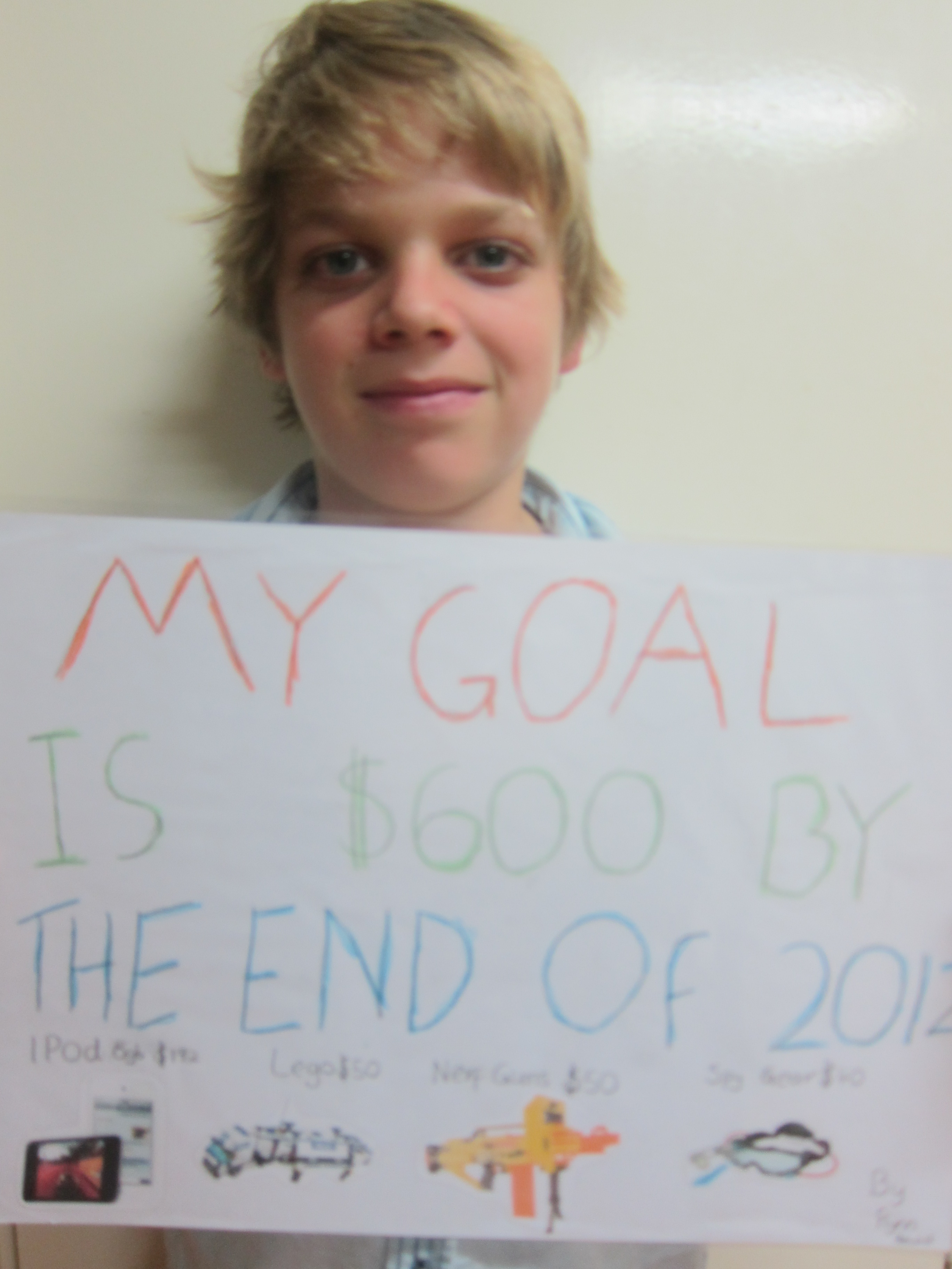 Flynn's vision board showing money goals and enterprise ideas for kids