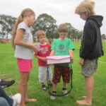 Business ideas for students shown through Chayse selling lolly bags with Kit and Amber