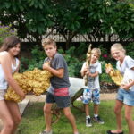 Kids holding large display gold nuggets outside the Perth Mint while learning about buying Perth Mint coins