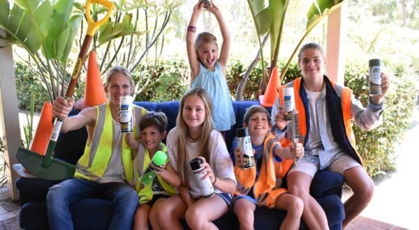 Kids running a curb painting business as part of raising entrepreneurial kids through real life enterprise experiences