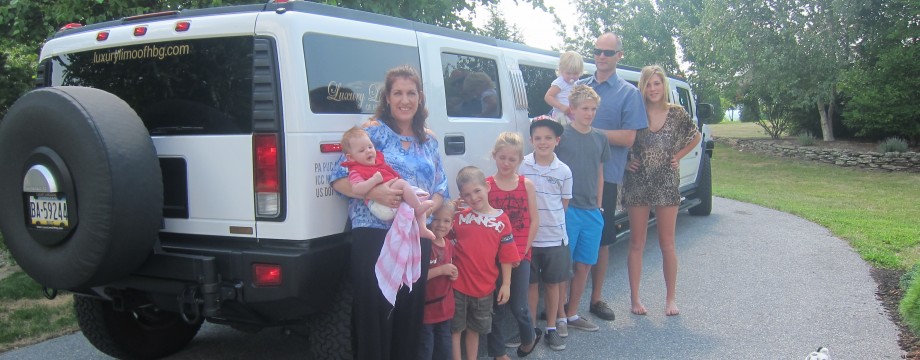 Howitt family beside a Hummer limousine at the start of their USA motorhome trip in 2011