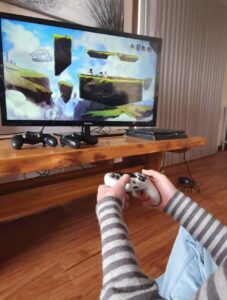 Akaisha using a controller while playing a video game