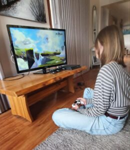Akaisha playing a video game at home and developing skills learned from video games