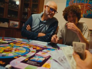 People gathered around a table playing the Cashflow 101 board game