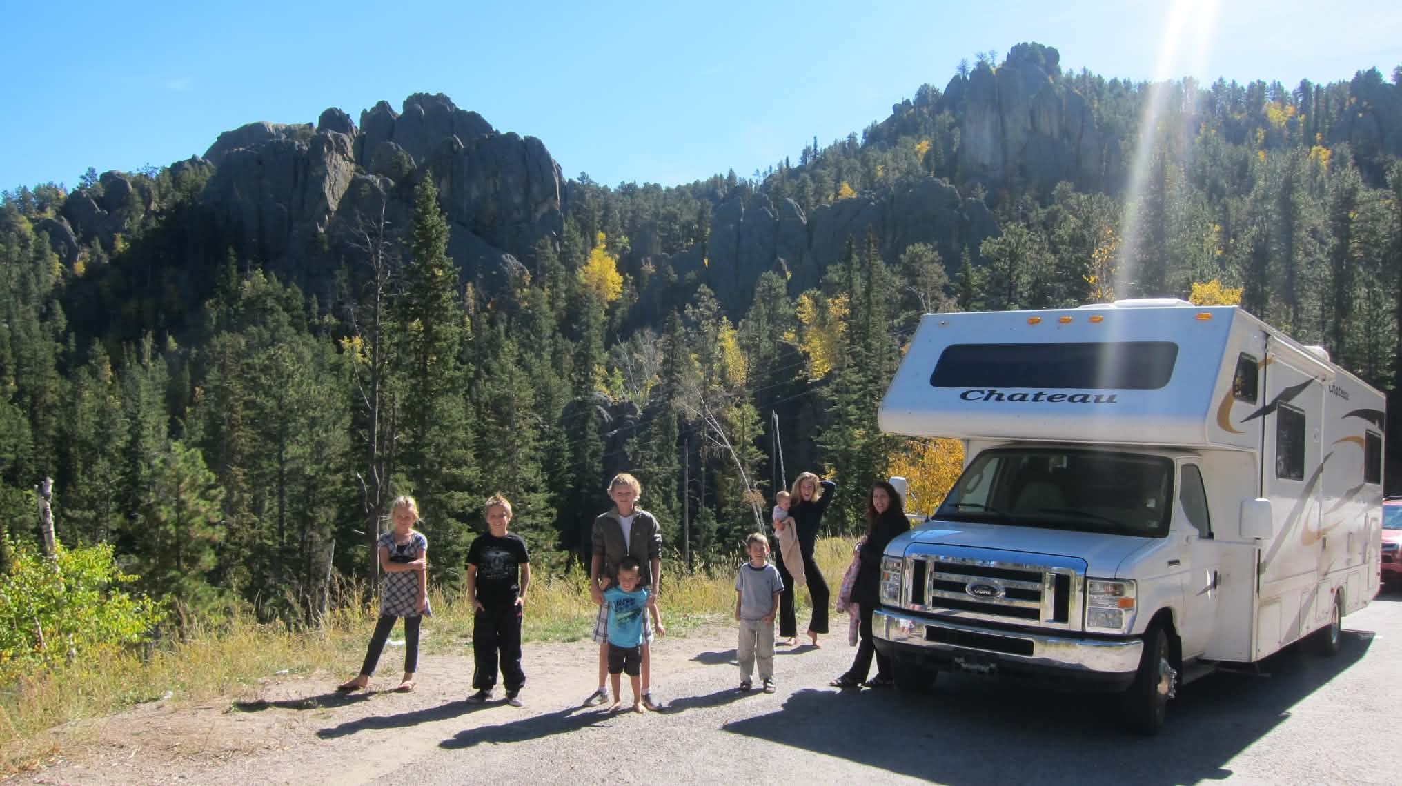 The Howitt children standing beside the motorhome they lived in while traveling through the USA and Canada